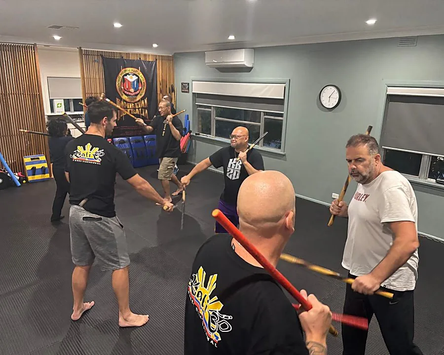 Adult students training with rattan sticks at Kali 3D Ashburton