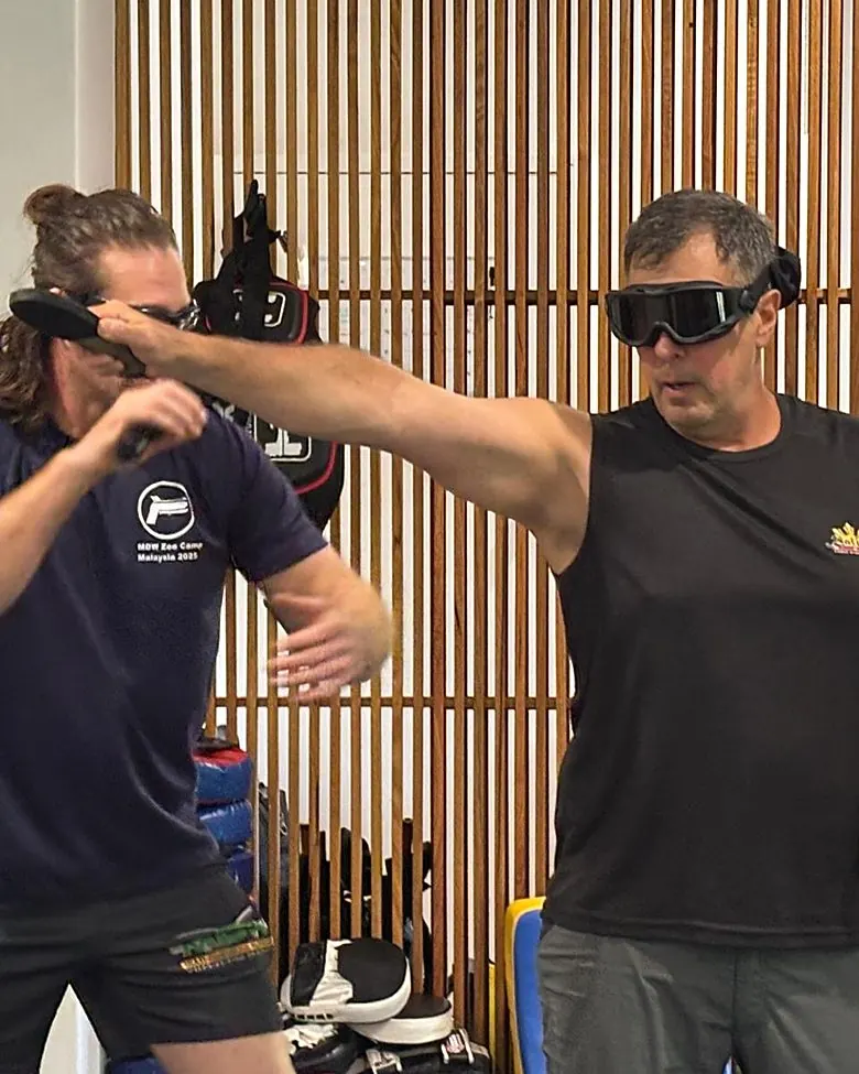 Two students in blindfold knife sparring drill