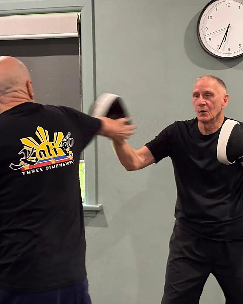 Two senior students working pads together