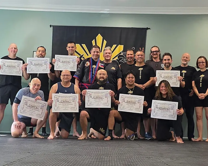 Large group photo holding IPMAF Kombatan certificates after a grading